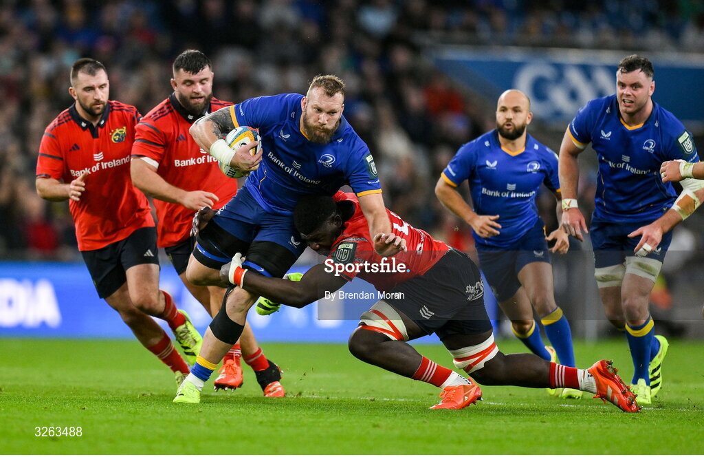 18 October 2025; RG Snyman of Leinster is tackled by Edwin Edogbo of Munster during the United Rugby Championship match between Leinster and Munster at Croke Park in Dublin. Photo by Brendan Moran/Sportsfile