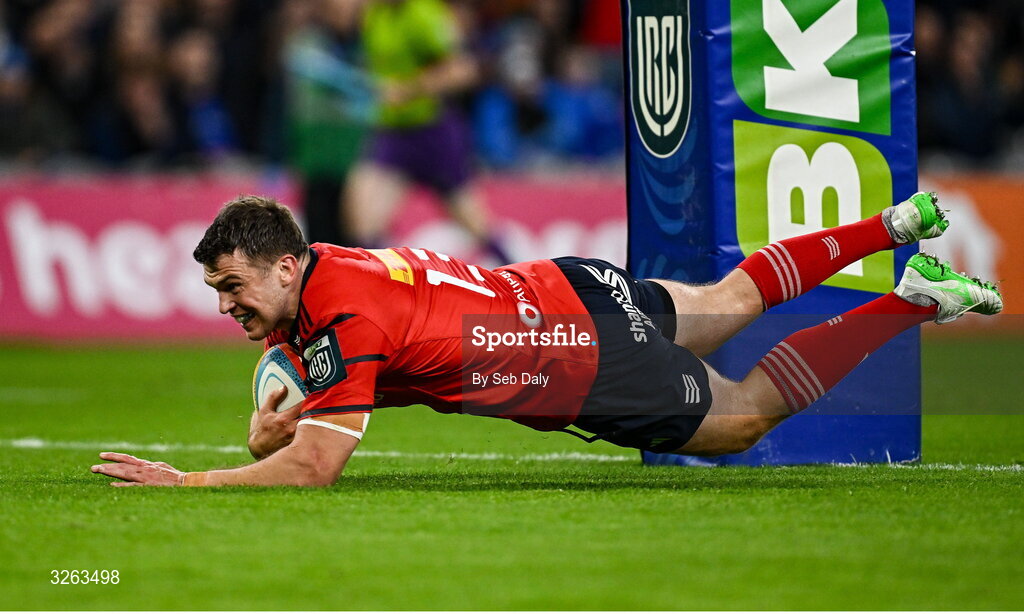 18 October 2025; Tom Farrell of Munster dives over to score his side's second try during the United Rugby Championship match between Leinster and Munster at Croke Park in Dublin. Photo by Seb Daly/Sportsfile
