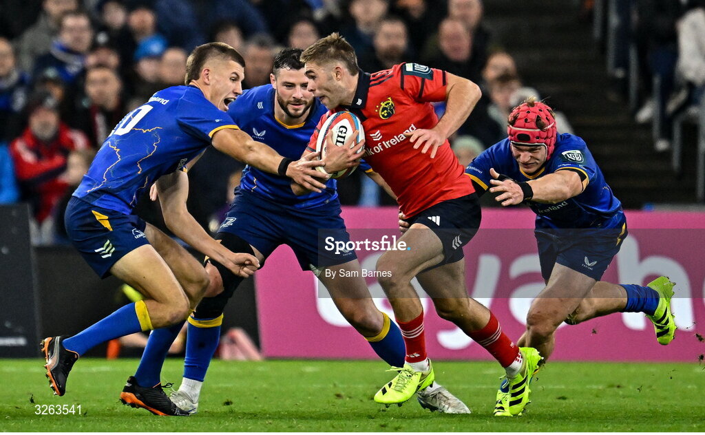 18 October 2025; Jack Crowley of Munster is tackled by Leinster players, from left, Sam Prendergast, Robbie Henshaw and Josh van der Flier during the United Rugby Championship match between Leinster and Munster at Croke Park in Dublin. Photo by Sam Barnes/Sportsfile