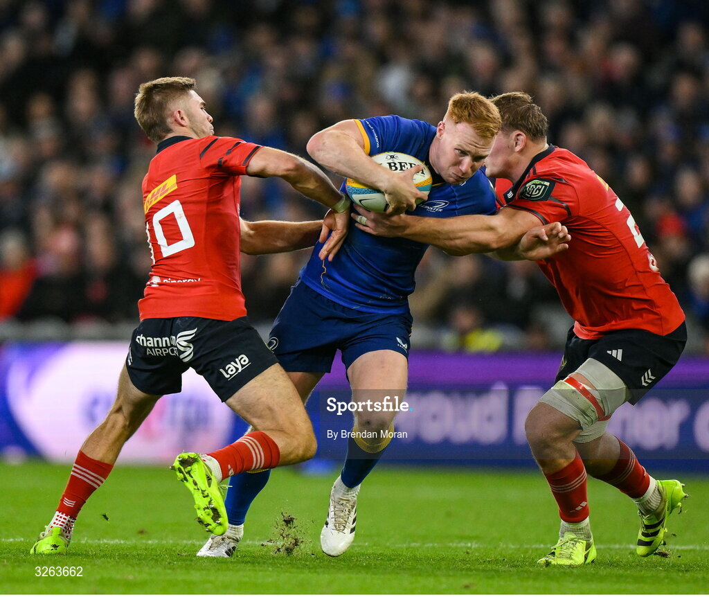 18 October 2025; Ciarán Frawley of Leinster is tackled by Jack Crowley, left, and Gavin Coombes of Munster during the United Rugby Championship match between Leinster and Munster at Croke Park in Dublin. Photo by Brendan Moran/Sportsfile
