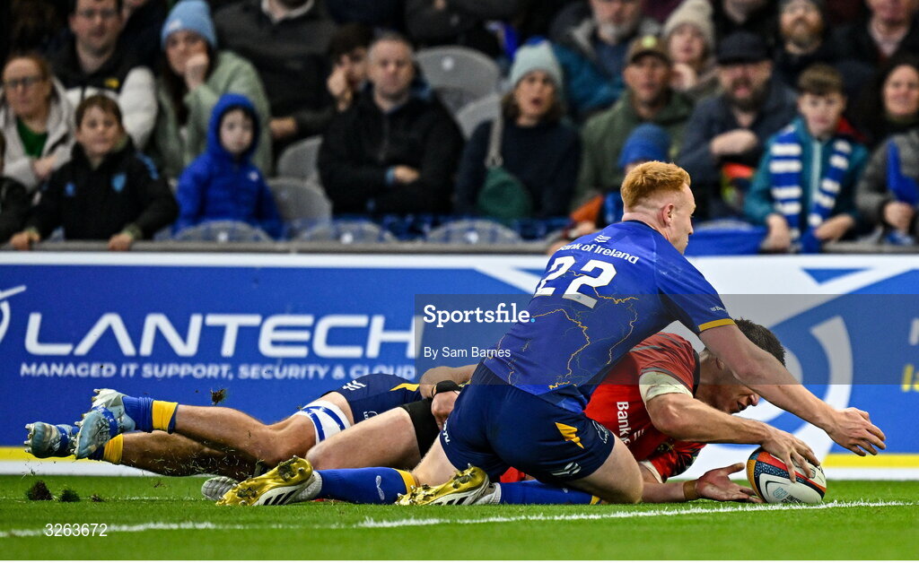 18 October 2025; Tom Farrell of Munster is tackled by Scott Penny, hidden, and Ciarán Frawley of Leinster, 22, which resulted in a penalty try during the United Rugby Championship match between Leinster and Munster at Croke Park in Dublin. Photo by Sam Barnes/Sportsfile