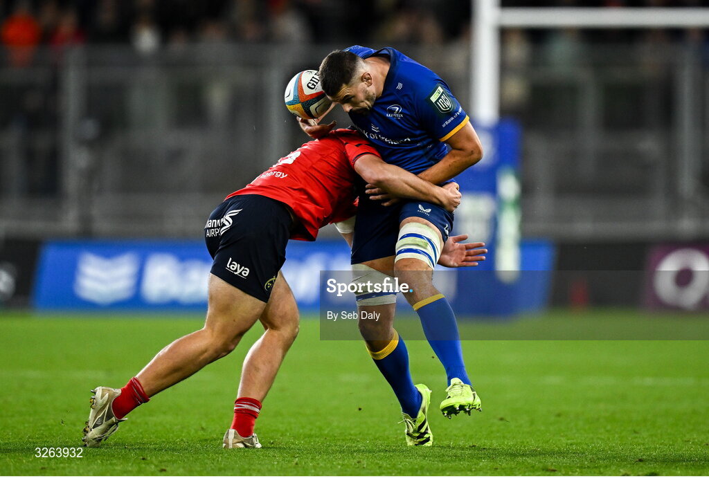 18 October 2025; Max Deegan of Leinster is tackled by Lee Barron of Munster during the United Rugby Championship match between Leinster and Munster at Croke Park in Dublin. Photo by Seb Daly/Sportsfile