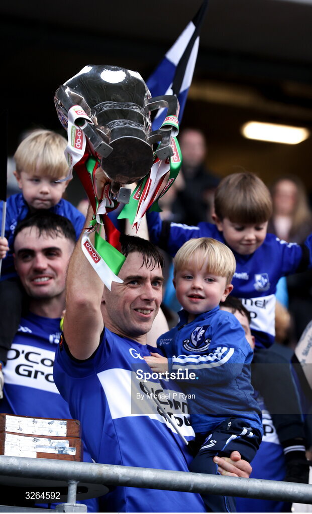 19 October 2025; Sarsfields captain Conor O'Sullivan lifts the Sean Óg Murphy cup with his son Quinn, age 3, after during the Cork County Senior Club Hurling Championship final match between Sarsfields and Midleton at SuperValu Páirc Uí Chaoimh in Cork. Photo by Michael P Ryan/Sportsfile