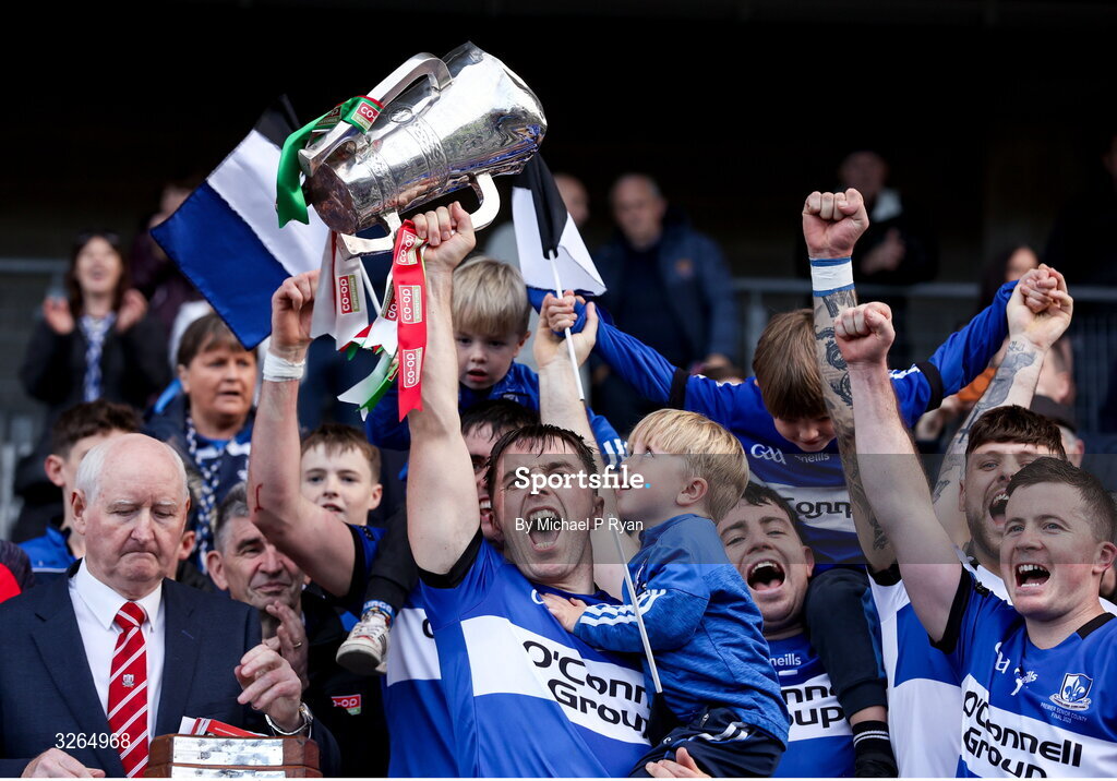 19 October 2025; Sarsfields captain Conor O'Sullivan lifts the Sean Óg Murphy cup with his son Quinn, age 3, after during the Cork County Senior Club Hurling Championship final match between Sarsfields and Midleton at SuperValu Páirc Uí Chaoimh in Cork. Photo by Michael P Ryan/Sportsfile