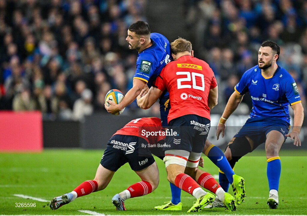 18 October 2025; Max Deegan of Leinster is tackled by Ethan Coughlan, left, and Gavin Coombes of Munster during the United Rugby Championship match between Leinster and Munster at Croke Park in Dublin. Photo by Sam Barnes/Sportsfile