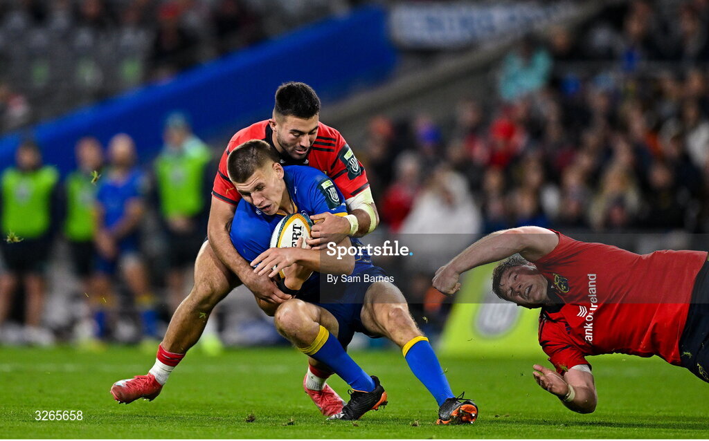 18 October 2025; Sam Prendergast of Leinster is tackled by Dan Kelly and Jack O’Donoghue of Munster during the United Rugby Championship match between Leinster and Munster at Croke Park in Dublin. Photo by Sam Barnes/Sportsfile