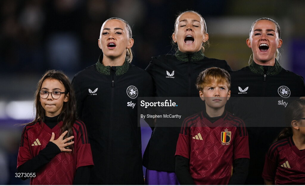 28 October 2025; Republic of Ireland players, from left, Katie McCabe, Grace Moloney and Jessie Stapleton during Amhrán na bhFiann before the UEFA Women's Nations League A/B promotion/relegation play-off second leg match between Belgium and Republic of Ireland at The King Power At Den Dreef Stadium in Leuven, Belgium. Photo by Stephen McCarthy/Sportsfile