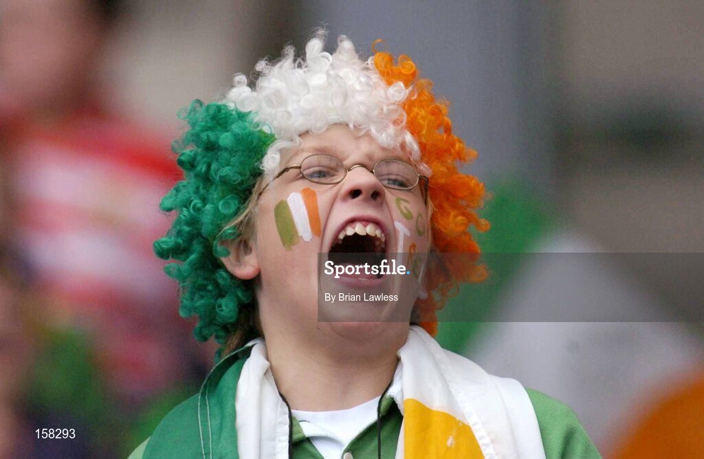 17 October 2004; A young Ireland fan cheers on her side during the match. Coca Cola International Rules Series 2004, First Test, Ireland v Australia, Croke Park, Dublin. Picture credit; Brian Lawless / SPORTSFILE *** Local Caption *** Any photograph taken by SPORTSFILE during, or in connection with, the 2004 Coca Cola International Rules Series which displays GAA logos or contains an image or part of an image of any GAA intellectual property, or, which contains images of a GAA player/players in their playing uniforms, may only be used for editorial and non-advertising purposes.  Use of photographs for advertising, as posters or for purchase separately is strictly prohibited unless prior written approval has been obtained from the Gaelic Athletic Association.