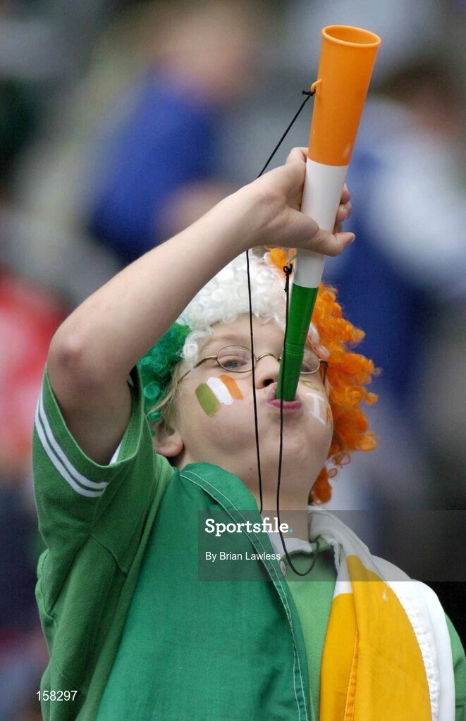 17 October 2004; A young Ireland fan cheers on her side during the match. Coca Cola International Rules Series 2004, First Test, Ireland v Australia, Croke Park, Dublin. Picture credit; Brian Lawless / SPORTSFILE *** Local Caption *** Any photograph taken by SPORTSFILE during, or in connection with, the 2004 Coca Cola International Rules Series which displays GAA logos or contains an image or part of an image of any GAA intellectual property, or, which contains images of a GAA player/players in their playing uniforms, may only be used for editorial and non-advertising purposes.  Use of photographs for advertising, as posters or for purchase separately is strictly prohibited unless prior written approval has been obtained from the Gaelic Athletic Association.