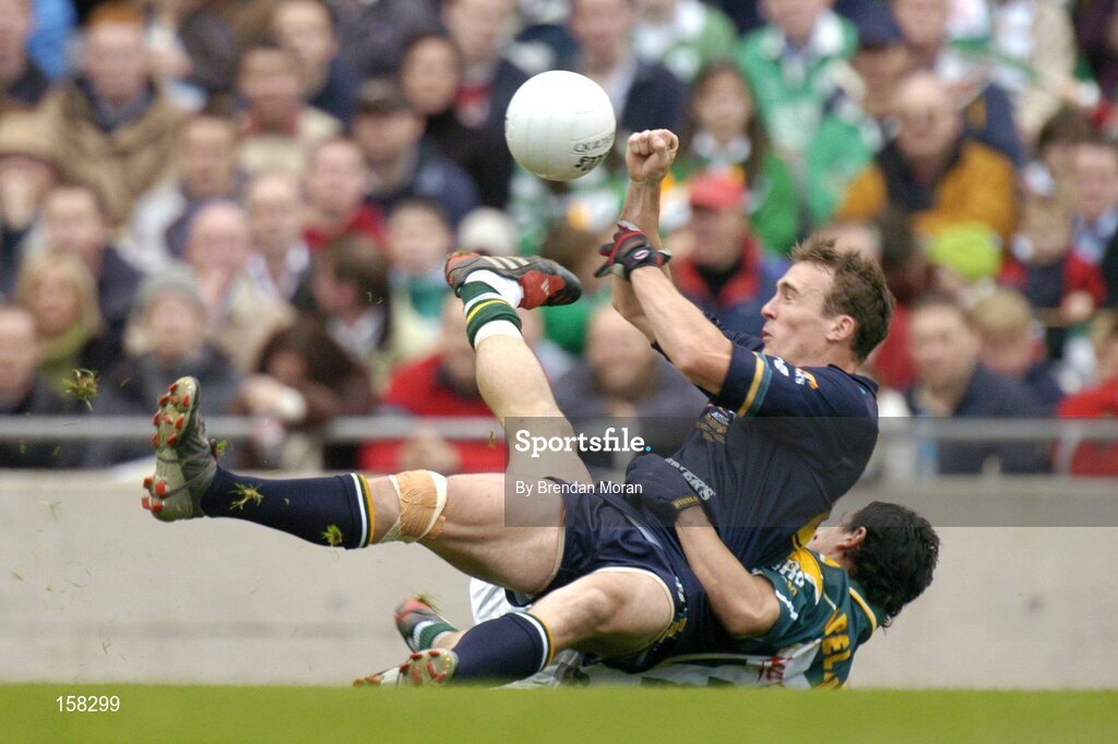 17 October 2004; Robert Haddrill, Australia, is tackled by Paul Galvin, Ireland. Coca Cola International Rules Series 2004, First Test, Ireland v Australia, Croke Park, Dublin. Picture credit; Brendan Moran / SPORTSFILE *** Local Caption *** Any photograph taken by SPORTSFILE during, or in connection with, the 2004 Coca Cola International Rules Series which displays GAA logos or contains an image or part of an image of any GAA intellectual property, or, which contains images of a GAA player/players in their playing uniforms, may only be used for editorial and non-advertising purposes.  Use of photographs for advertising, as posters or for purchase separately is strictly prohibited unless prior written approval has been obtained from the Gaelic Athletic Association.