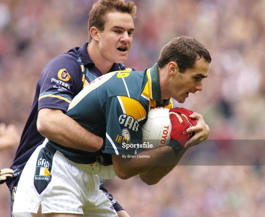 17 October 2004; Sean Marty Lockhart, Ireland, in action against Brad Green, Australia. Coca Cola International Rules Series 2004, First Test, Ireland v Australia, Croke Park, Dublin. Picture credit; Brian Lawless / SPORTSFILE *** Local Caption *** Any photograph taken by SPORTSFILE during, or in connection with, the 2004 Coca Cola International Rules Series which displays GAA logos or contains an image or part of an image of any GAA intellectual property, or, which contains images of a GAA player/players in their playing uniforms, may only be used for editorial and non-advertising purposes.  Use of photographs for advertising, as posters or for purchase separately is strictly prohibited unless prior written approval has been obtained from the Gaelic Athletic Association.