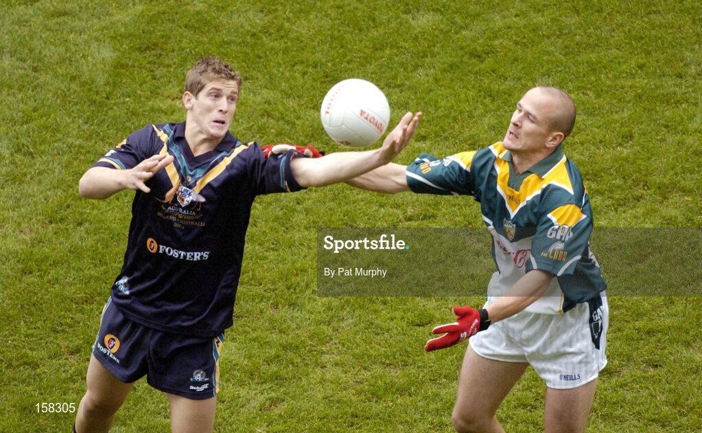 17 October 2004; Tom Kelly, Ireland, in action against Nick Dal Santo, Australia. Coca Cola International Rules Series 2004, First Test, Ireland v Australia, Croke Park, Dublin. Picture credit; Pat Murphy / SPORTSFILE *** Local Caption *** Any photograph taken by SPORTSFILE during, or in connection with, the 2004 Coca Cola International Rules Series which displays GAA logos or contains an image or part of an image of any GAA intellectual property, or, which contains images of a GAA player/players in their playing uniforms, may only be used for editorial and non-advertising purposes.  Use of photographs for advertising, as posters or for purchase separately is strictly prohibited unless prior written approval has been obtained from the Gaelic Athletic Association.