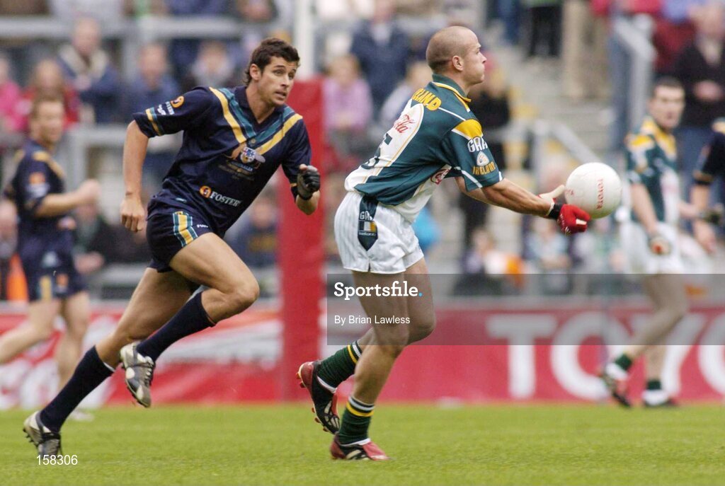 17 October 2004; Tom Kelly, Ireland, in action against Andrew Embley, Australia. Coca Cola International Rules Series 2004, First Test, Ireland v Australia, Croke Park, Dublin. Picture credit; Brian Lawless / SPORTSFILE *** Local Caption *** Any photograph taken by SPORTSFILE during, or in connection with, the 2004 Coca Cola International Rules Series which displays GAA logos or contains an image or part of an image of any GAA intellectual property, or, which contains images of a GAA player/players in their playing uniforms, may only be used for editorial and non-advertising purposes.  Use of photographs for advertising, as posters or for purchase separately is strictly prohibited unless prior written approval has been obtained from the Gaelic Athletic Association.