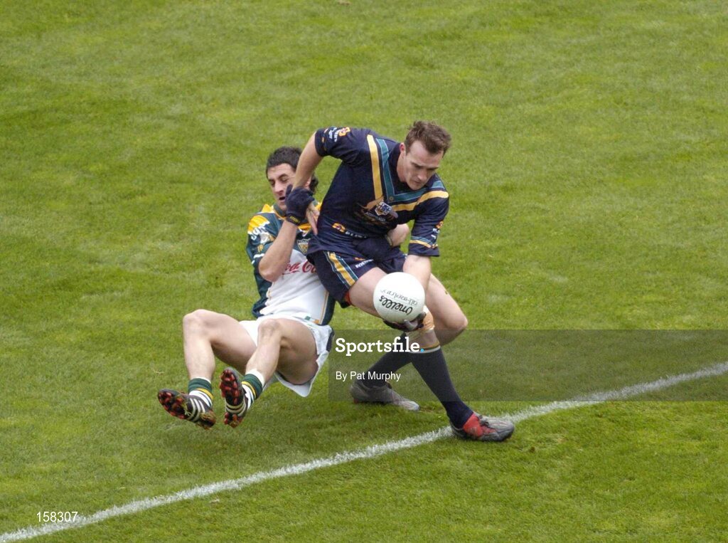 17 October 2004; Robert Haddrill, Australia, in action against Paul Galvin, Ireland. Coca Cola International Rules Series 2004, First Test, Ireland v Australia, Croke Park, Dublin. Picture credit; Pat Murphy / SPORTSFILE *** Local Caption *** Any photograph taken by SPORTSFILE during, or in connection with, the 2004 Coca Cola International Rules Series which displays GAA logos or contains an image or part of an image of any GAA intellectual property, or, which contains images of a GAA player/players in their playing uniforms, may only be used for editorial and non-advertising purposes.  Use of photographs for advertising, as posters or for purchase separately is strictly prohibited unless prior written approval has been obtained from the Gaelic Athletic Association.