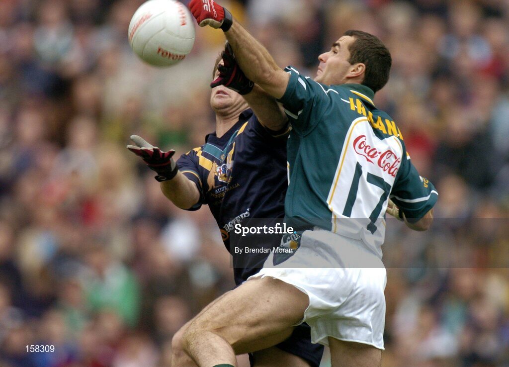 17 October 2004; Sean Martin Lockhart, Ireland, in action against Joel Bowden, Australia. Coca Cola International Rules Series 2004, First Test, Ireland v Australia, Croke Park, Dublin. Picture credit; Brendan Moran / SPORTSFILE *** Local Caption *** Any photograph taken by SPORTSFILE during, or in connection with, the 2004 Coca Cola International Rules Series which displays GAA logos or contains an image or part of an image of any GAA intellectual property, or, which contains images of a GAA player/players in their playing uniforms, may only be used for editorial and non-advertising purposes.  Use of photographs for advertising, as posters or for purchase separately is strictly prohibited unless prior written approval has been obtained from the Gaelic Athletic Association.