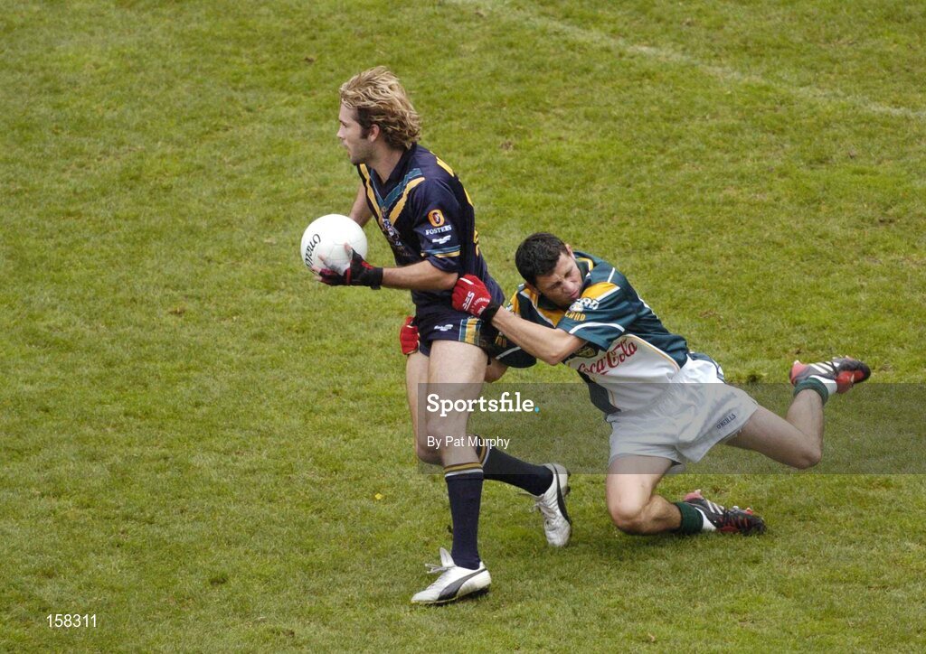 17 October 2004; Mark McVeigh, Australia, in action against Alan Brogan, Ireland. Coca Cola International Rules Series 2004, First Test, Ireland v Australia, Croke Park, Dublin. Picture credit; Pat Murphy / SPORTSFILE *** Local Caption *** Any photograph taken by SPORTSFILE during, or in connection with, the 2004 Coca Cola International Rules Series which displays GAA logos or contains an image or part of an image of any GAA intellectual property, or, which contains images of a GAA player/players in their playing uniforms, may only be used for editorial and non-advertising purposes.  Use of photographs for advertising, as posters or for purchase separately is strictly prohibited unless prior written approval has been obtained from the Gaelic Athletic Association.