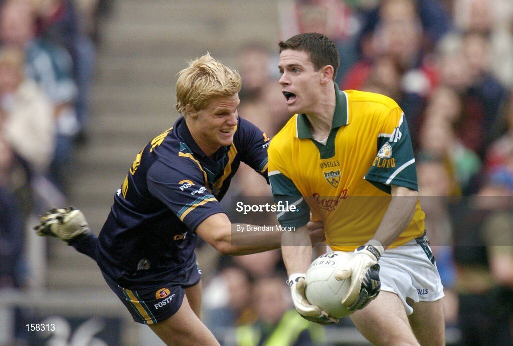 17 October 2004; Stephen Cluxton, Ireland, in action against Nick Riewoldt, Australia. Coca Cola International Rules Series 2004, First Test, Ireland v Australia, Croke Park, Dublin. Picture credit; Brendan Moran / SPORTSFILE *** Local Caption *** Any photograph taken by SPORTSFILE during, or in connection with, the 2004 Coca Cola International Rules Series which displays GAA logos or contains an image or part of an image of any GAA intellectual property, or, which contains images of a GAA player/players in their playing uniforms, may only be used for editorial and non-advertising purposes.  Use of photographs for advertising, as posters or for purchase separately is strictly prohibited unless prior written approval has been obtained from the Gaelic Athletic Association.