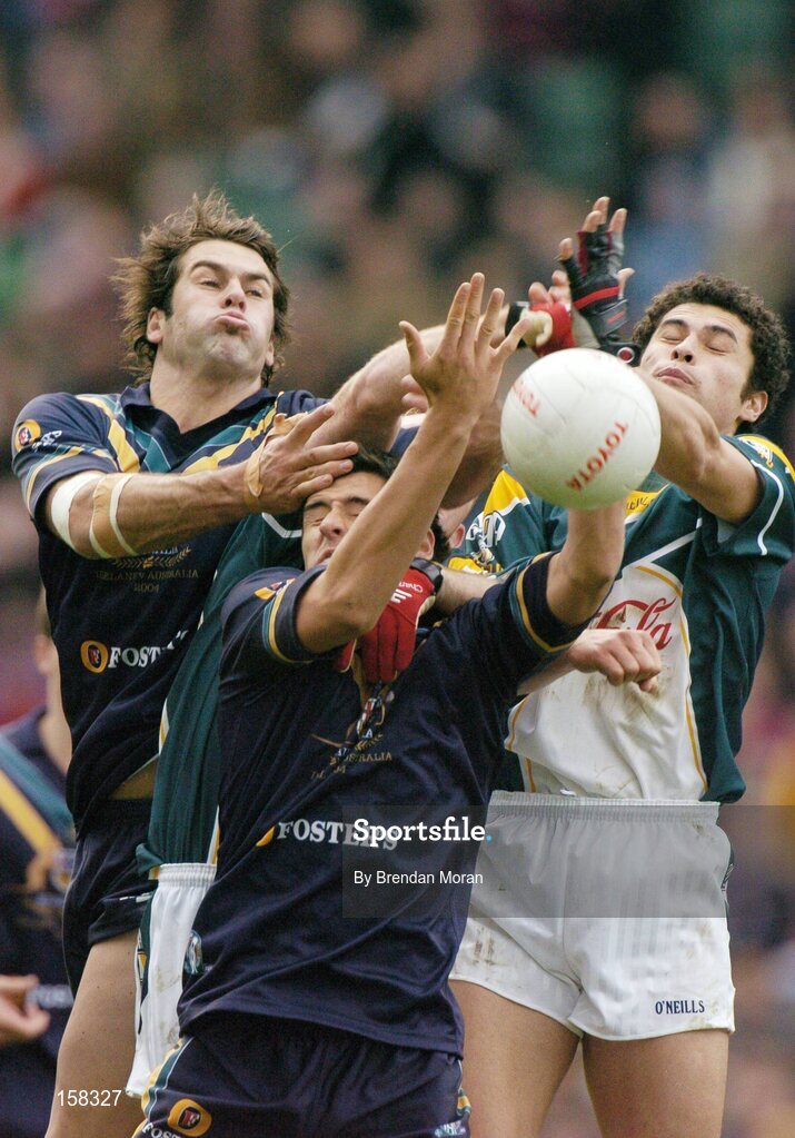 17 October 2004; Dean Solomon, left, and Andrew Embley, Australia, in action against Sean Og O hAilpin, and Martin McGrath, hidden, Ireland. Coca Cola International Rules Series 2004, First Test, Ireland v Australia, Croke Park, Dublin. Picture credit; Brendan Moran / SPORTSFILE *** Local Caption *** Any photograph taken by SPORTSFILE during, or in connection with, the 2004 Coca Cola International Rules Series which displays GAA logos or contains an image or part of an image of any GAA intellectual property, or, which contains images of a GAA player/players in their playing uniforms, may only be used for editorial and non-advertising purposes.  Use of photographs for advertising, as posters or for purchase separately is strictly prohibited unless prior written approval has been obtained from the Gaelic Athletic Association.