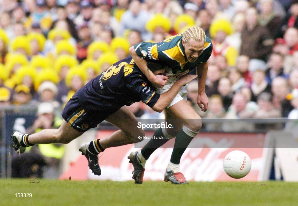 17 October 2004; Ciaran McDonald, Ireland, in action against Brady Rawlings, Australia. Coca Cola International Rules Series 2004, First Test, Ireland v Australia, Croke Park, Dublin. Picture credit; Brian Lawless / SPORTSFILE *** Local Caption *** Any photograph taken by SPORTSFILE during, or in connection with, the 2004 Coca Cola International Rules Series which displays GAA logos or contains an image or part of an image of any GAA intellectual property, or, which contains images of a GAA player/players in their playing uniforms, may only be used for editorial and non-advertising purposes.  Use of photographs for advertising, as posters or for purchase separately is strictly prohibited unless prior written approval has been obtained from the Gaelic Athletic Association.
