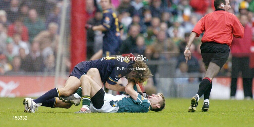 17 October 2004; Matty Forde, Ireland, in a tussle with Mark McVeigh, Australia, for which McVeigh received a yellow card and was sin-binned. Coca Cola International Rules Series 2004, First Test, Ireland v Australia, Croke Park, Dublin. Picture credit; Brendan Moran / SPORTSFILE *** Local Caption *** Any photograph taken by SPORTSFILE during, or in connection with, the 2004 Coca Cola International Rules Series which displays GAA logos or contains an image or part of an image of any GAA intellectual property, or, which contains images of a GAA player/players in their playing uniforms, may only be used for editorial and non-advertising purposes.  Use of photographs for advertising, as posters or for purchase separately is strictly prohibited unless prior written approval has been obtained from the Gaelic Athletic Association.