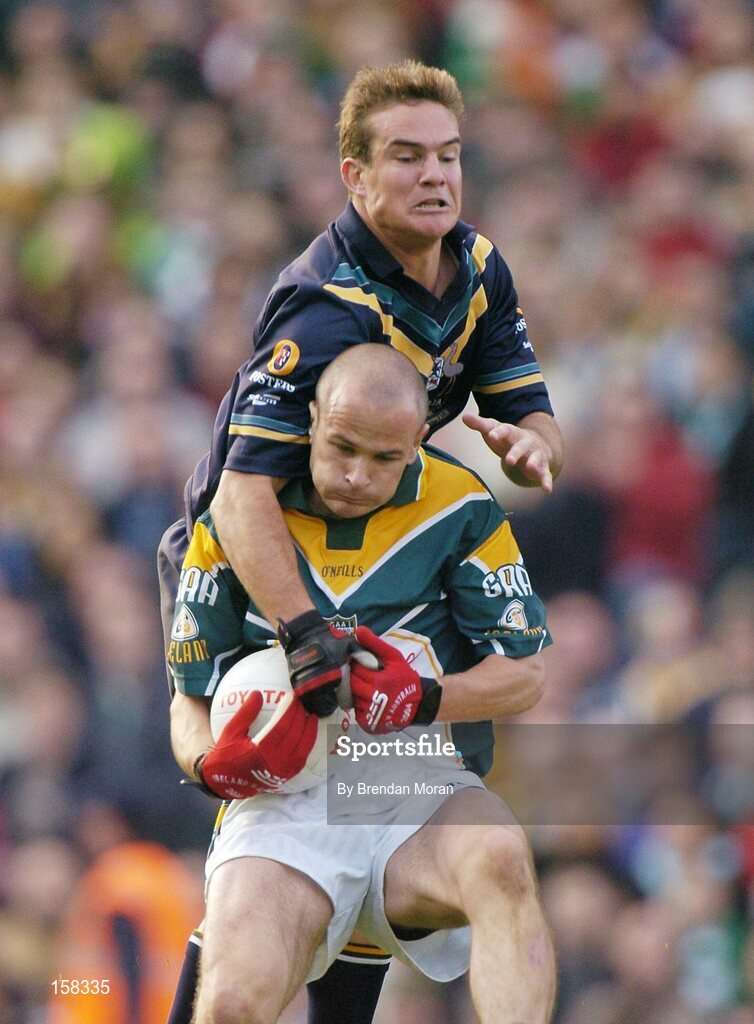 17 October 2004; Tom Kelly, Ireland, in action against Brad Green, Australia. Coca Cola International Rules Series 2004, First Test, Ireland v Australia, Croke Park, Dublin. Picture credit; Brendan Moran / SPORTSFILE *** Local Caption *** Any photograph taken by SPORTSFILE during, or in connection with, the 2004 Coca Cola International Rules Series which displays GAA logos or contains an image or part of an image of any GAA intellectual property, or, which contains images of a GAA player/players in their playing uniforms, may only be used for editorial and non-advertising purposes.  Use of photographs for advertising, as posters or for purchase separately is strictly prohibited unless prior written approval has been obtained from the Gaelic Athletic Association.