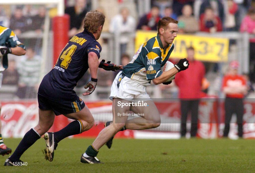 17 October 2004; Brendan Coulter, Ireland, in action against Jason Johnson, Australia. Coca Cola International Rules Series 2004, First Test, Ireland v Australia, Croke Park, Dublin. Picture credit; Brian Lawless / SPORTSFILE *** Local Caption *** Any photograph taken by SPORTSFILE during, or in connection with, the 2004 Coca Cola International Rules Series which displays GAA logos or contains an image or part of an image of any GAA intellectual property, or, which contains images of a GAA player/players in their playing uniforms, may only be used for editorial and non-advertising purposes.  Use of photographs for advertising, as posters or for purchase separately is strictly prohibited unless prior written approval has been obtained from the Gaelic Athletic Association.