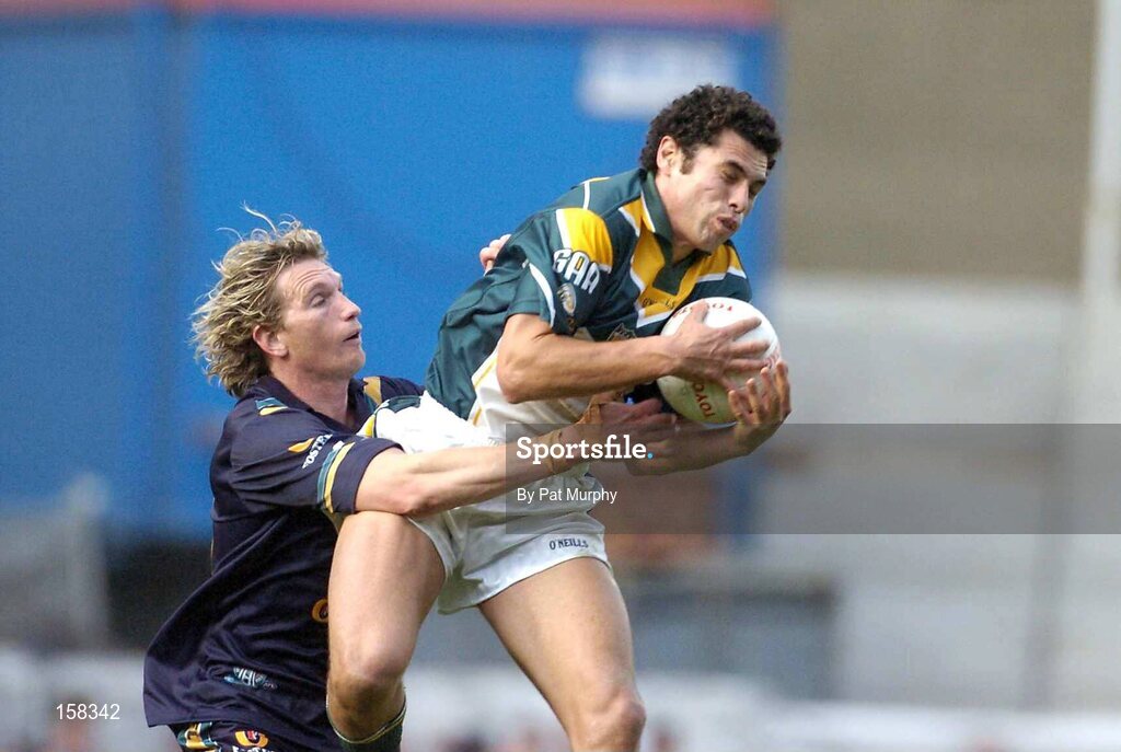 17 October 2004; Sean Og O'hAilpin, Ireland, in action against James Hird, Australia. Coca Cola International Rules Series 2004, First Test, Ireland v Australia, Croke Park, Dublin. Picture credit; Pat Murphy / SPORTSFILE *** Local Caption *** Any photograph taken by SPORTSFILE during, or in connection with, the 2004 Coca Cola International Rules Series which displays GAA logos or contains an image or part of an image of any GAA intellectual property, or, which contains images of a GAA player/players in their playing uniforms, may only be used for editorial and non-advertising purposes.  Use of photographs for advertising, as posters or for purchase separately is strictly prohibited unless prior written approval has been obtained from the Gaelic Athletic Association.