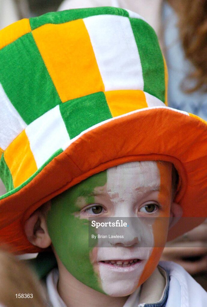 17 October 2004; A young Ireland fan watches on during the match. Coca Cola International Rules Series 2004, First Test, Ireland v Australia, Croke Park, Dublin. Picture credit; Brian Lawless / SPORTSFILE *** Local Caption *** Any photograph taken by SPORTSFILE during, or in connection with, the 2004 Coca Cola International Rules Series which displays GAA logos or contains an image or part of an image of any GAA intellectual property, or, which contains images of a GAA player/players in their playing uniforms, may only be used for editorial and non-advertising purposes.  Use of photographs for advertising, as posters or for purchase separately is strictly prohibited unless prior written approval has been obtained from the Gaelic Athletic Association.