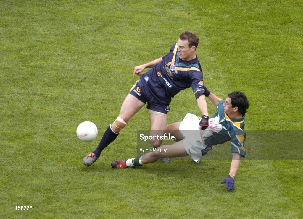 17 October 2004; Robert Haddrill, Australia, in action against Paul Galvin, Ireland. Coca Cola International Rules Series 2004, First Test, Ireland v Australia, Croke Park, Dublin. Picture credit; Pat Murphy / SPORTSFILE *** Local Caption *** Any photograph taken by SPORTSFILE during, or in connection with, the 2004 Coca Cola International Rules Series which displays GAA logos or contains an image or part of an image of any GAA intellectual property, or, which contains images of a GAA player/players in their playing uniforms, may only be used for editorial and non-advertising purposes.  Use of photographs for advertising, as posters or for purchase separately is strictly prohibited unless prior written approval has been obtained from the Gaelic Athletic Association.