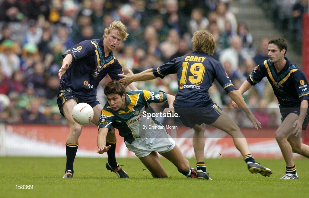 17 October 2004; Setanta O hAilpin, Ireland, in action against Craig Bolton, left, Joel Corey (19) and Brad Rawlings, Australia. Coca Cola International Rules Series 2004, First Test, Ireland v Australia, Croke Park, Dublin. Picture credit; Brendan Moran / SPORTSFILE *** Local Caption *** Any photograph taken by SPORTSFILE during, or in connection with, the 2004 Coca Cola International Rules Series which displays GAA logos or contains an image or part of an image of any GAA intellectual property, or, which contains images of a GAA player/players in their playing uniforms, may only be used for editorial and non-advertising purposes.  Use of photographs for advertising, as posters or for purchase separately is strictly prohibited unless prior written approval has been obtained from the Gaelic Athletic Association.