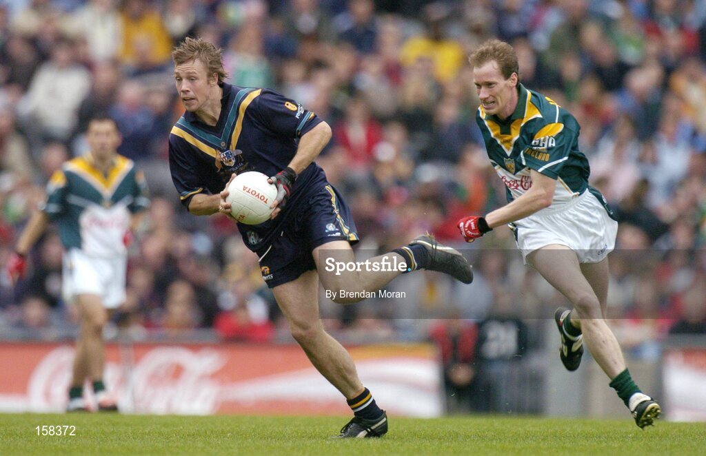 17 October 2004; Max Hudghton, Australia, in action against James Nallen, Ireland. Coca Cola International Rules Series 2004, First Test, Ireland v Australia, Croke Park, Dublin. Picture credit; Brendan Moran / SPORTSFILE *** Local Caption *** Any photograph taken by SPORTSFILE during, or in connection with, the 2004 Coca Cola International Rules Series which displays GAA logos or contains an image or part of an image of any GAA intellectual property, or, which contains images of a GAA player/players in their playing uniforms, may only be used for editorial and non-advertising purposes.  Use of photographs for advertising, as posters or for purchase separately is strictly prohibited unless prior written approval has been obtained from the Gaelic Athletic Association.