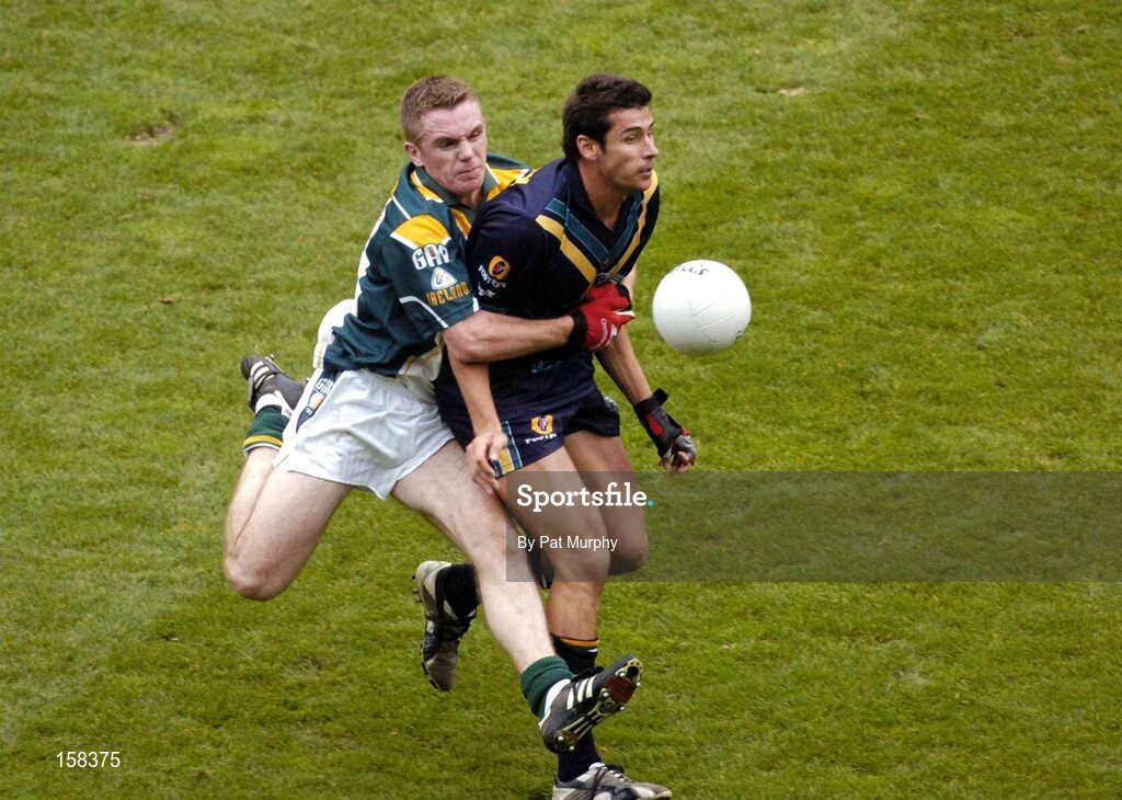 17 October 2004; Andrew Embley, Australia, in action against Martin McGrath, Ireland. Coca Cola International Rules Series 2004, First Test, Ireland v Australia, Croke Park, Dublin. Picture credit; Pat Murphy / SPORTSFILE *** Local Caption *** Any photograph taken by SPORTSFILE during, or in connection with, the 2004 Coca Cola International Rules Series which displays GAA logos or contains an image or part of an image of any GAA intellectual property, or, which contains images of a GAA player/players in their playing uniforms, may only be used for editorial and non-advertising purposes.  Use of photographs for advertising, as posters or for purchase separately is strictly prohibited unless prior written approval has been obtained from the Gaelic Athletic Association.