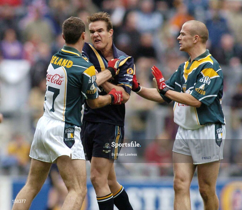 17 October 2004; Australia's Brad Green gets to grips with Ireland's Sean Martin Lockhart, left, as Tom Kelly looks on. Coca Cola International Rules Series 2004, First Test, Ireland v Australia, Croke Park, Dublin. Picture credit; Brian Lawless / SPORTSFILE *** Local Caption *** Any photograph taken by SPORTSFILE during, or in connection with, the 2004 Coca Cola International Rules Series which displays GAA logos or contains an image or part of an image of any GAA intellectual property, or, which contains images of a GAA player/players in their playing uniforms, may only be used for editorial and non-advertising purposes.  Use of photographs for advertising, as posters or for purchase separately is strictly prohibited unless prior written approval has been obtained from the Gaelic Athletic Association.