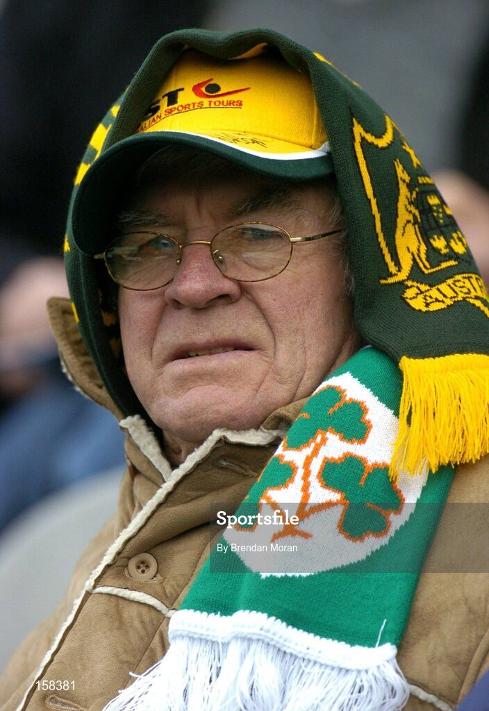 17 October 2004; A supporter wraps up well with both an Australian and Irish scarf to keep out the cold during the game. Coca Cola International Rules Series 2004, First Test, Ireland v Australia, Croke Park, Dublin. Picture credit; Brendan Moran / SPORTSFILE *** Local Caption *** Any photograph taken by SPORTSFILE during, or in connection with, the 2004 Coca Cola International Rules Series which displays GAA logos or contains an image or part of an image of any GAA intellectual property, or, which contains images of a GAA player/players in their playing uniforms, may only be used for editorial and non-advertising purposes.  Use of photographs for advertising, as posters or for purchase separately is strictly prohibited unless prior written approval has been obtained from the Gaelic Athletic Association.