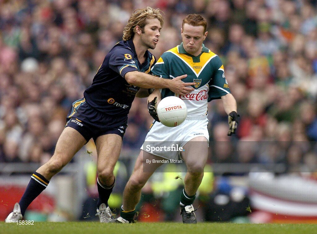 17 October 2004; Brendan Coulter, Ireland, in action against Mark McVeigh, Australia. Coca Cola International Rules Series 2004, First Test, Ireland v Australia, Croke Park, Dublin. Picture credit; Brendan Moran / SPORTSFILE *** Local Caption *** Any photograph taken by SPORTSFILE during, or in connection with, the 2004 Coca Cola International Rules Series which displays GAA logos or contains an image or part of an image of any GAA intellectual property, or, which contains images of a GAA player/players in their playing uniforms, may only be used for editorial and non-advertising purposes.  Use of photographs for advertising, as posters or for purchase separately is strictly prohibited unless prior written approval has been obtained from the Gaelic Athletic Association.