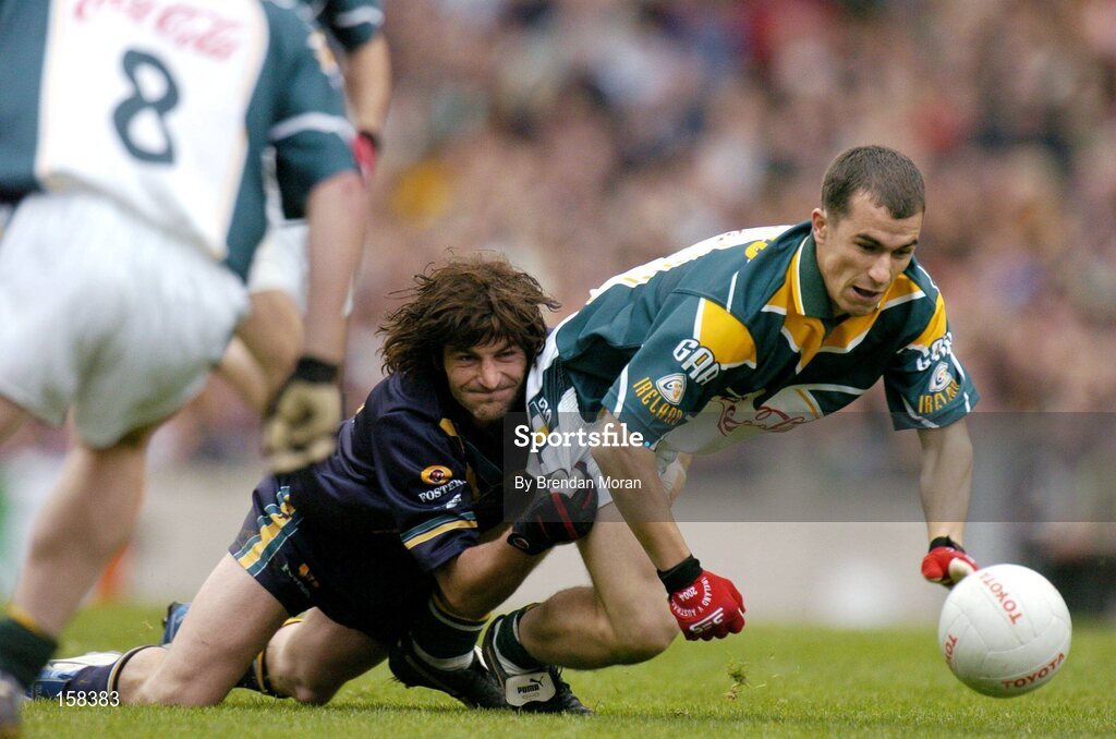 17 October 2004; Des Dolan, Ireland, in action against Brett Kirk, Australia. Coca Cola International Rules Series 2004, First Test, Ireland v Australia, Croke Park, Dublin. Picture credit; Brendan Moran / SPORTSFILE *** Local Caption *** Any photograph taken by SPORTSFILE during, or in connection with, the 2004 Coca Cola International Rules Series which displays GAA logos or contains an image or part of an image of any GAA intellectual property, or, which contains images of a GAA player/players in their playing uniforms, may only be used for editorial and non-advertising purposes.  Use of photographs for advertising, as posters or for purchase separately is strictly prohibited unless prior written approval has been obtained from the Gaelic Athletic Association.