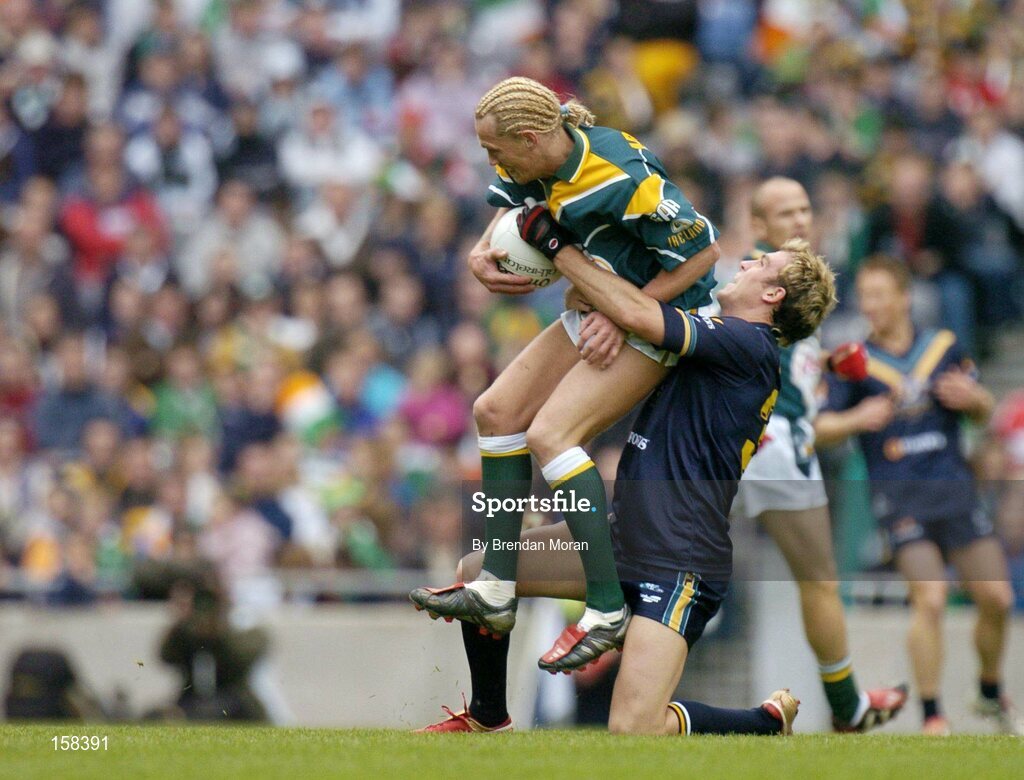 17 October 2004; Ciaran McDonald, Ireland, in action against Cameron Bruce, Australia. Coca Cola International Rules Series 2004, First Test, Ireland v Australia, Croke Park, Dublin. Picture credit; Brendan Moran / SPORTSFILE *** Local Caption *** Any photograph taken by SPORTSFILE during, or in connection with, the 2004 Coca Cola International Rules Series which displays GAA logos or contains an image or part of an image of any GAA intellectual property, or, which contains images of a GAA player/players in their playing uniforms, may only be used for editorial and non-advertising purposes.  Use of photographs for advertising, as posters or for purchase separately is strictly prohibited unless prior written approval has been obtained from the Gaelic Athletic Association.