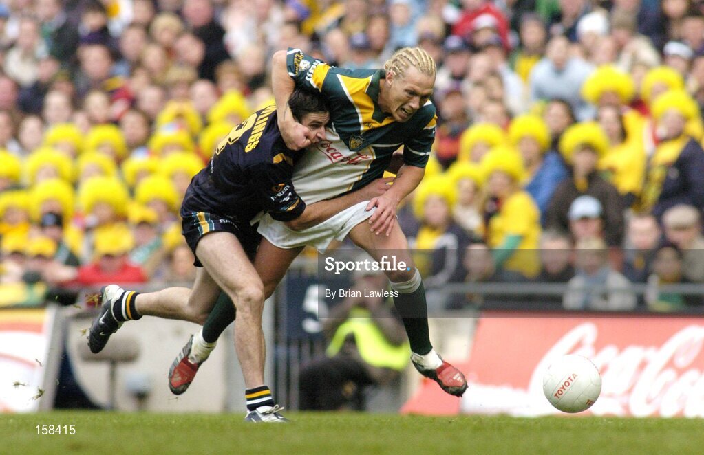17 October 2004; Ciaran McDonald, Ireland, in action against Brady Rawlings, Australia. Coca Cola International Rules Series 2004, First Test, Ireland v Australia, Croke Park, Dublin. Picture credit; Brian Lawless / SPORTSFILE *** Local Caption *** Any photograph taken by SPORTSFILE during, or in connection with, the 2004 Coca Cola International Rules Series which displays GAA logos or contains an image or part of an image of any GAA intellectual property, or, which contains images of a GAA player/players in their playing uniforms, may only be used for editorial and non-advertising purposes.  Use of photographs for advertising, as posters or for purchase separately is strictly prohibited unless prior written approval has been obtained from the Gaelic Athletic Association.