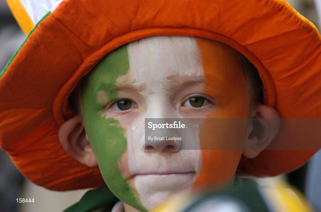 17 October 2004; A young Ireland fan keeps a close eye on the game. Coca Cola International Rules Series 2004, First Test, Ireland v Australia, Croke Park, Dublin. Picture credit; Brian Lawless / SPORTSFILE *** Local Caption *** Any photograph taken by SPORTSFILE during, or in connection with, the 2004 Coca Cola International Rules Series which displays GAA logos or contains an image or part of an image of any GAA intellectual property, or, which contains images of a GAA player/players in their playing uniforms, may only be used for editorial and non-advertising purposes.  Use of photographs for advertising, as posters or for purchase separately is strictly prohibited unless prior written approval has been obtained from the Gaelic Athletic Association.