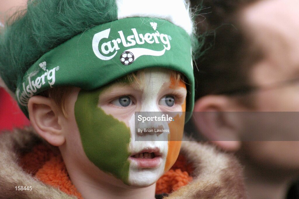 17 October 2004; A young Ireland fan looks on during the game. Coca Cola International Rules Series 2004, First Test, Ireland v Australia, Croke Park, Dublin. Picture credit; Brian Lawless / SPORTSFILE *** Local Caption *** Any photograph taken by SPORTSFILE during, or in connection with, the 2004 Coca Cola International Rules Series which displays GAA logos or contains an image or part of an image of any GAA intellectual property, or, which contains images of a GAA player/players in their playing uniforms, may only be used for editorial and non-advertising purposes.  Use of photographs for advertising, as posters or for purchase separately is strictly prohibited unless prior written approval has been obtained from the Gaelic Athletic Association.