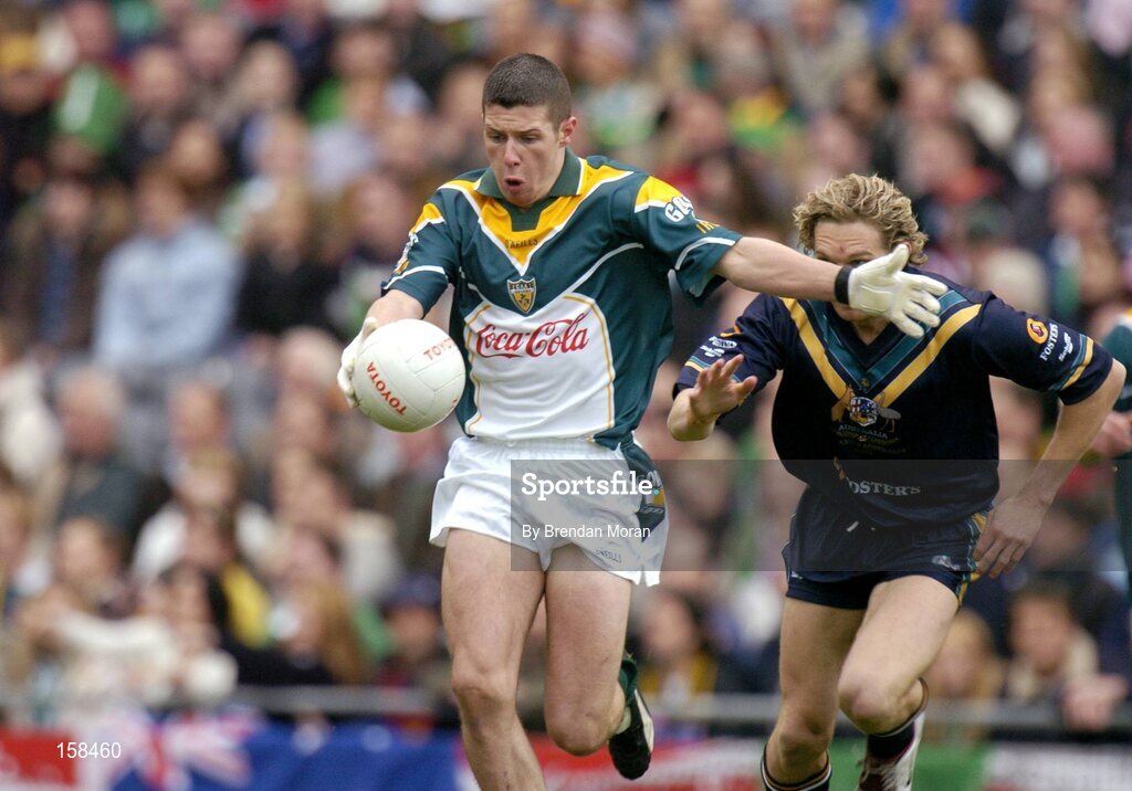 17 October 2004; Sean Cavanagh, Ireland, in action against Mark McVeigh, Australia. Coca Cola International Rules Series 2004, First Test, Ireland v Australia, Croke Park, Dublin. Picture credit; Brendan Moran / SPORTSFILE *** Local Caption *** Any photograph taken by SPORTSFILE during, or in connection with, the 2004 Coca Cola International Rules Series which displays GAA logos or contains an image or part of an image of any GAA intellectual property, or, which contains images of a GAA player/players in their playing uniforms, may only be used for editorial and non-advertising purposes.  Use of photographs for advertising, as posters or for purchase separately is strictly prohibited unless prior written approval has been obtained from the Gaelic Athletic Association.