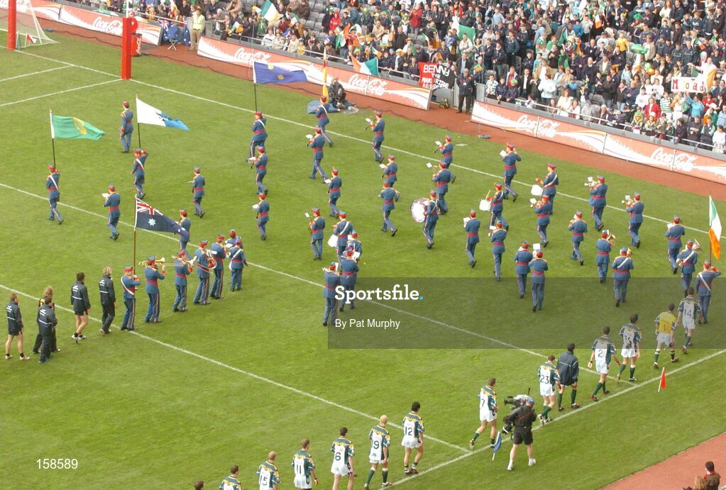 17 October 2004; The Ireland and Australian team march behind the Artane Band during the pre-match parade. Coca Cola International Rules Series 2004, First Test, Ireland v Australia, Croke Park, Dublin. Picture credit; Pat Murphy / SPORTSFILE *** Local Caption *** Any photograph taken by SPORTSFILE during, or in connection with, the 2004 Coca Cola International Rules Series, which displays GAA logos or contains an image or part of an image of any GAA intellectual property, or, which contains images of a GAA player/players in their playing uniforms, may only be used for editorial and non-advertising purposes.  Use of photographs for advertising, as posters or for purchase separately is strictly prohibited unless prior written approval has been obtained from the Gaelic Athletic Association.