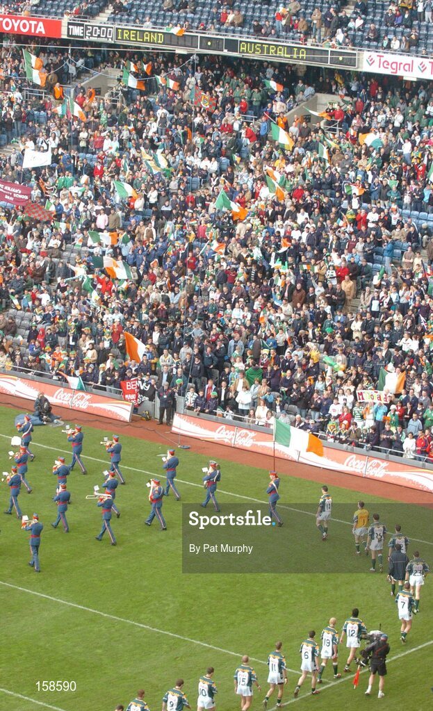 17 October 2004; The Ireland team march behind the Artane Band during the pre-match parade. Coca Cola International Rules Series 2004, First Test, Ireland v Australia, Croke Park, Dublin. Picture credit; Pat Murphy / SPORTSFILE *** Local Caption *** Any photograph taken by SPORTSFILE during, or in connection with, the 2004 Coca Cola International Rules Series, which displays GAA logos or contains an image or part of an image of any GAA intellectual property, or, which contains images of a GAA player/players in their playing uniforms, may only be used for editorial and non-advertising purposes.  Use of photographs for advertising, as posters or for purchase separately is strictly prohibited unless prior written approval has been obtained from the Gaelic Athletic Association.