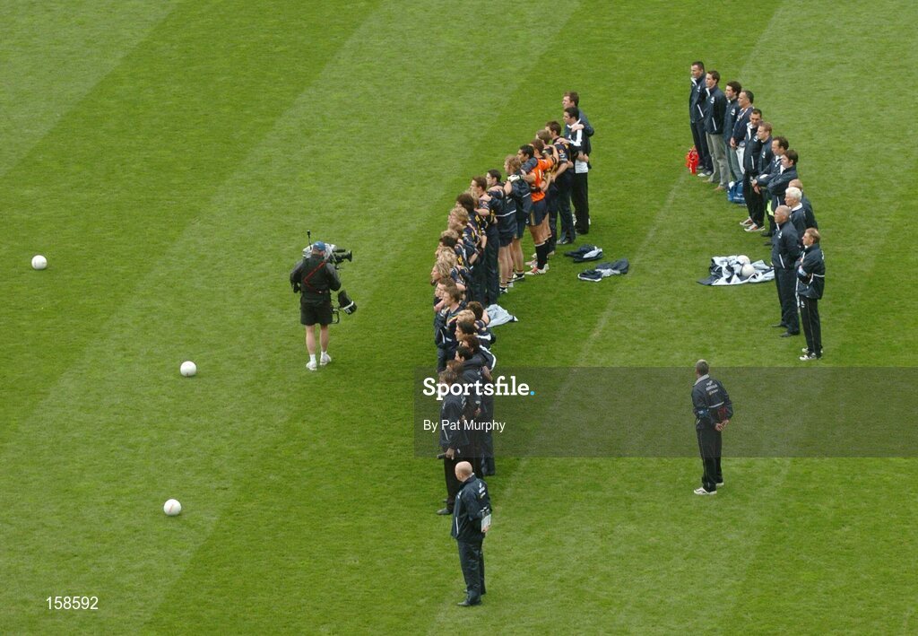17 October 2004; The Australian players and backroom staff stand for the national anthem. Coca Cola International Rules Series 2004, First Test, Ireland v Australia, Croke Park, Dublin. Picture credit; Pat Murphy / SPORTSFILE *** Local Caption *** Any photograph taken by SPORTSFILE during, or in connection with, the 2004 Coca Cola International Rules Series, which displays GAA logos or contains an image or part of an image of any GAA intellectual property, or, which contains images of a GAA player/players in their playing uniforms, may only be used for editorial and non-advertising purposes.  Use of photographs for advertising, as posters or for purchase separately is strictly prohibited unless prior written approval has been obtained from the Gaelic Athletic Association.