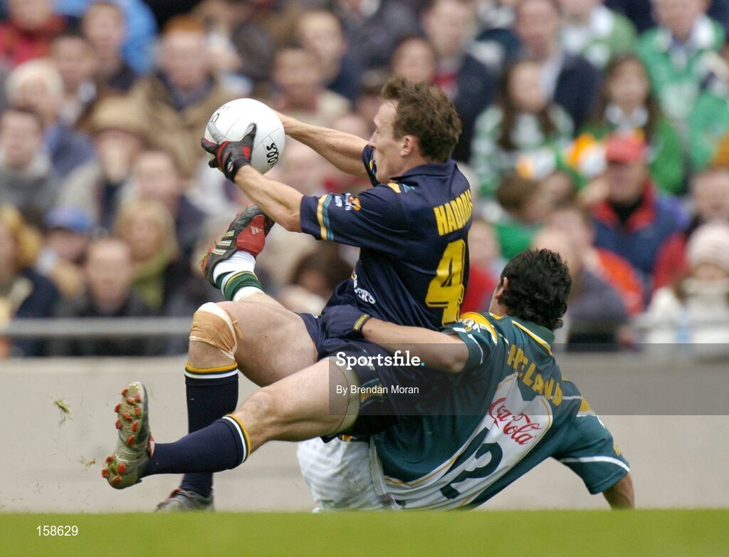 17 October 2004; Robert Haddrill, Australia, is tackled by Paul Galvin, Ireland. Coca Cola International Rules Series 2004, First Test, Ireland v Australia, Croke Park, Dublin. Picture credit; Brendan Moran / SPORTSFILE *** Local Caption *** Any photograph taken by SPORTSFILE during, or in connection with, the 2004 Coca Cola International Rules Series which displays GAA logos or contains an image or part of an image of any GAA intellectual property, or, which contains images of a GAA player/players in their playing uniforms, may only be used for editorial and non-advertising purposes.  Use of photographs for advertising, as posters or for purchase separately is strictly prohibited unless prior written approval has been obtained from the Gaelic Athletic Association.