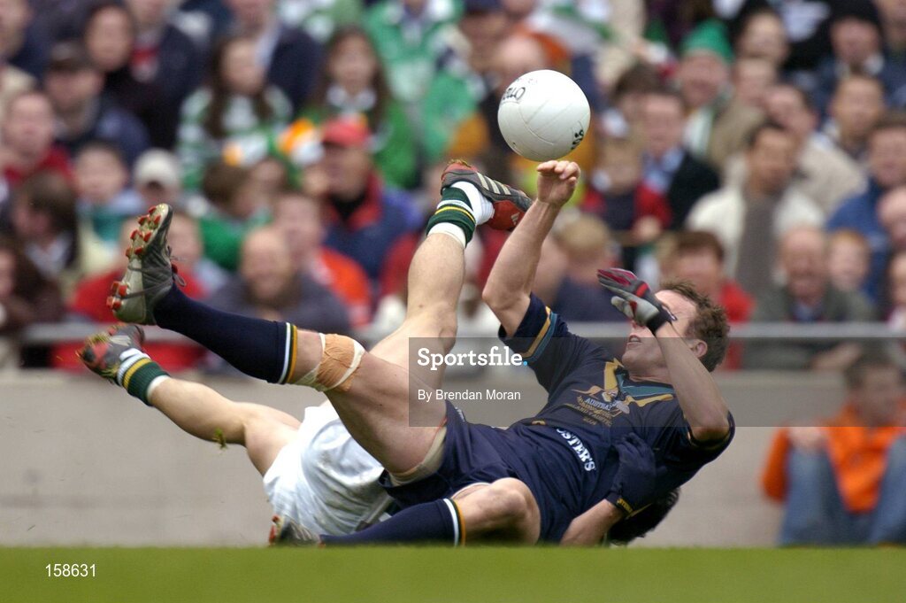 17 October 2004; Robert Haddrill, Australia, is tackled by Paul Galvin, Ireland. Coca Cola International Rules Series 2004, First Test, Ireland v Australia, Croke Park, Dublin. Picture credit; Brendan Moran / SPORTSFILE *** Local Caption *** Any photograph taken by SPORTSFILE during, or in connection with, the 2004 Coca Cola International Rules Series which displays GAA logos or contains an image or part of an image of any GAA intellectual property, or, which contains images of a GAA player/players in their playing uniforms, may only be used for editorial and non-advertising purposes.  Use of photographs for advertising, as posters or for purchase separately is strictly prohibited unless prior written approval has been obtained from the Gaelic Athletic Association.
