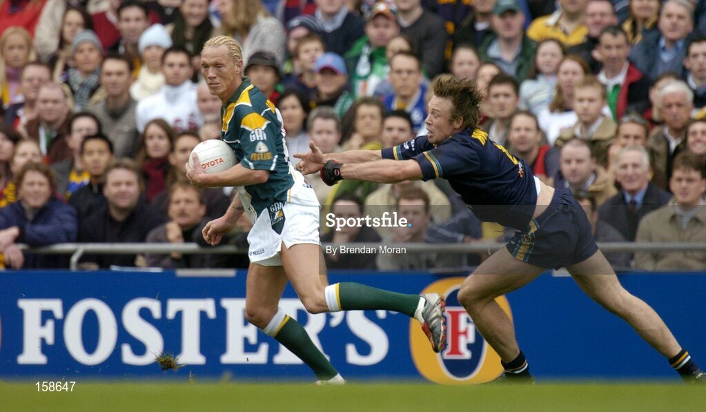 17 October 2004; Ciaran McDonald, Ireland, in action against Max Hudghton, Australia. Coca Cola International Rules Series 2004, First Test, Ireland v Australia, Croke Park, Dublin. Picture credit; Brendan Moran / SPORTSFILE *** Local Caption *** Any photograph taken by SPORTSFILE during, or in connection with, the 2004 Coca Cola International Rules Series which displays GAA logos or contains an image or part of an image of any GAA intellectual property, or, which contains images of a GAA player/players in their playing uniforms, may only be used for editorial and non-advertising purposes.  Use of photographs for advertising, as posters or for purchase separately is strictly prohibited unless prior written approval has been obtained from the Gaelic Athletic Association.