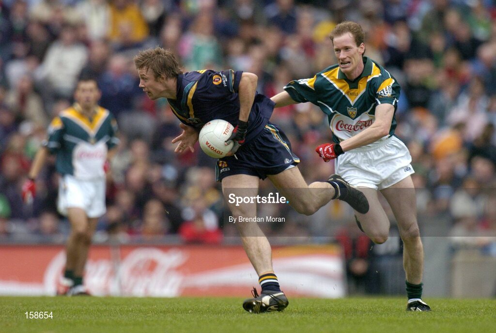 17 October 2004; Max Hudghton, Australia, in action against James Nallen, Ireland. Coca Cola International Rules Series 2004, First Test, Ireland v Australia, Croke Park, Dublin. Picture credit; Brendan Moran / SPORTSFILE *** Local Caption *** Any photograph taken by SPORTSFILE during, or in connection with, the 2004 Coca Cola International Rules Series which displays GAA logos or contains an image or part of an image of any GAA intellectual property, or, which contains images of a GAA player/players in their playing uniforms, may only be used for editorial and non-advertising purposes.  Use of photographs for advertising, as posters or for purchase separately is strictly prohibited unless prior written approval has been obtained from the Gaelic Athletic Association.