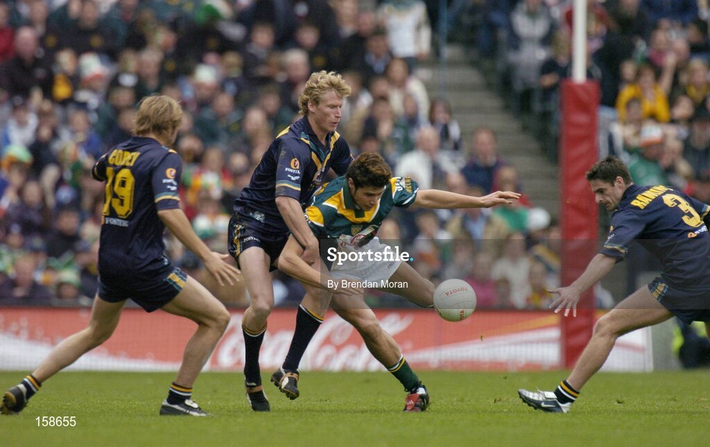 17 October 2004; Setanta O hAilpin, Ireland, in action against Joel Corey (19), Craig Bolton and Brady Rawlings (3), Australia. Coca Cola International Rules Series 2004, First Test, Ireland v Australia, Croke Park, Dublin. Picture credit; Brendan Moran / SPORTSFILE *** Local Caption *** Any photograph taken by SPORTSFILE during, or in connection with, the 2004 Coca Cola International Rules Series which displays GAA logos or contains an image or part of an image of any GAA intellectual property, or, which contains images of a GAA player/players in their playing uniforms, may only be used for editorial and non-advertising purposes.  Use of photographs for advertising, as posters or for purchase separately is strictly prohibited unless prior written approval has been obtained from the Gaelic Athletic Association.