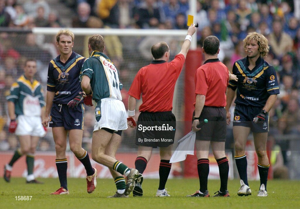 17 October 2004; Mark McVeigh, Australia, is shown a yellow card by referee Stephen McBurney and subsequently sin-binned. Coca Cola International Rules Series 2004, First Test, Ireland v Australia, Croke Park, Dublin. Picture credit; Brendan Moran / SPORTSFILE *** Local Caption *** Any photograph taken by SPORTSFILE during, or in connection with, the 2004 Coca Cola International Rules Series which displays GAA logos or contains an image or part of an image of any GAA intellectual property, or, which contains images of a GAA player/players in their playing uniforms, may only be used for editorial and non-advertising purposes.  Use of photographs for advertising, as posters or for purchase separately is strictly prohibited unless prior written approval has been obtained from the Gaelic Athletic Association.